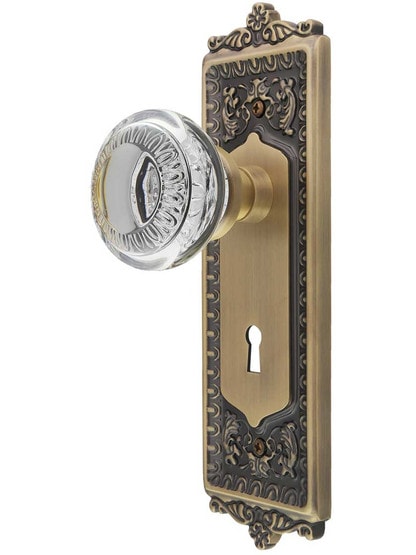 Egg and Dart Style Door Set with Ovolo Crystal-Glass Knobs and Keyhole in Antique Brass.